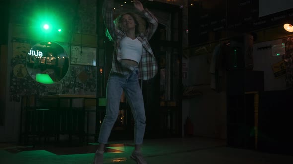 Carefree Crazy Girl Dancing on the Dance Floor in a Nightclub