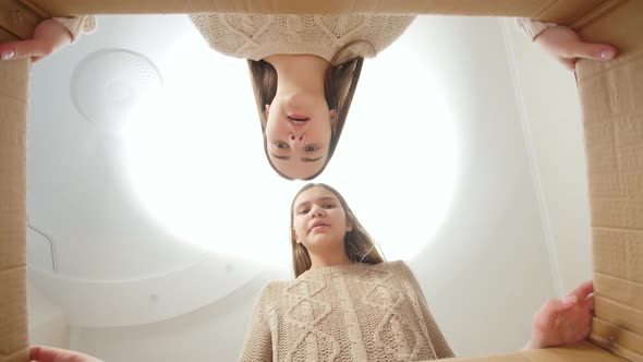 Two Disappointed Girls Opening Big Cardboard Box and Found Nothing