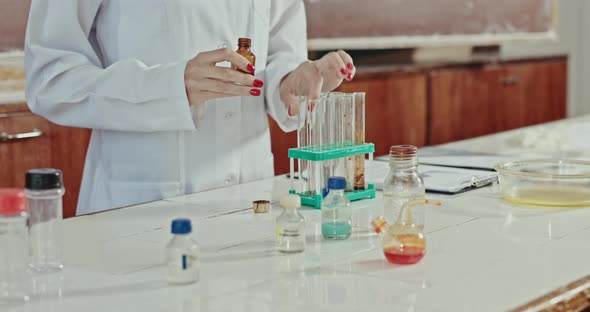 Female Scientist Performing Chemical Experiment