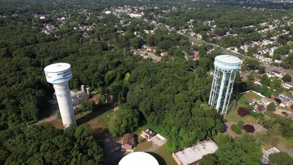 A high angle view over water towers in a suburban neighborhood on Long Island, NY on a sunny day. Th