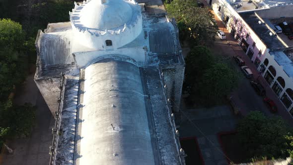 Dynamic aerial pull back and tilt up to reveal the Cathedral de San Gervasio after sunrise in Vallad