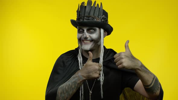 Frightening Man in Skeleton Halloween Cosplay Makeup Looking at Camera, Showning Thumbs Up Gesture