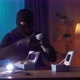 Thief in a Balaclava Finds Jewelry and Money on a Table in the House - VideoHive Item for Sale