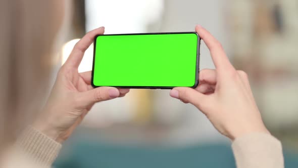 Woman Watching Smartphone with Green Screen Chroma Screen