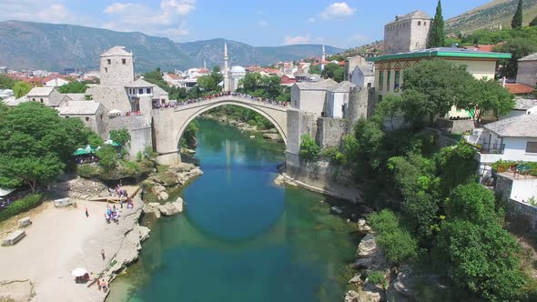 Aerial view of men jumping from bridge in Mostar