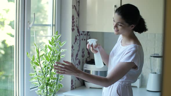 Young Woman Caring for Houseplant