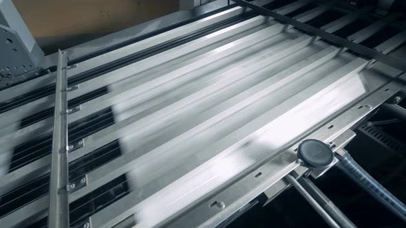 Printing Conveyor Belt with White Paper Moving Under