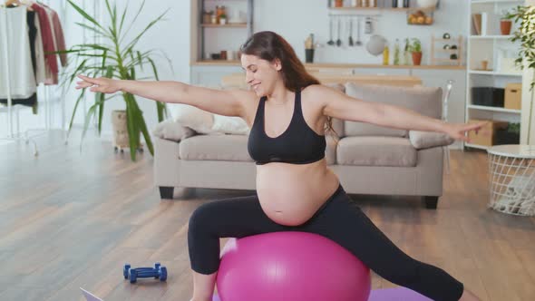 Happy Pregnant Woman Doing Online Fitness at Home