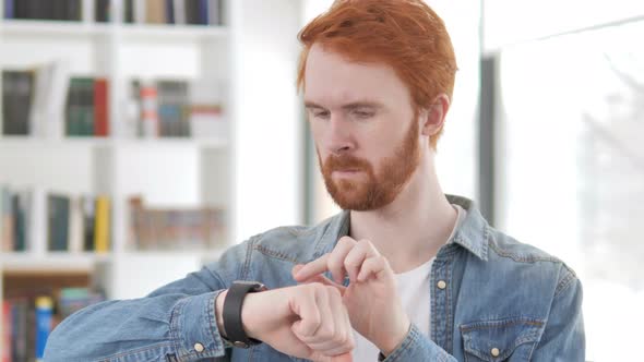 Casual Redhead Man Using Smartwatch