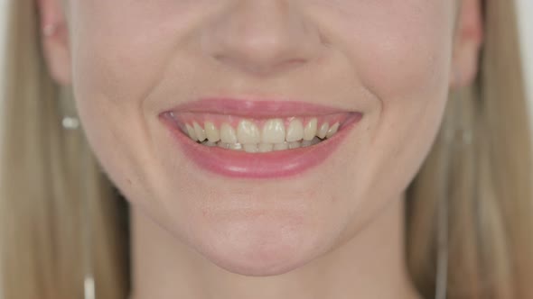 Smiling Lips of Young Woman on White Background