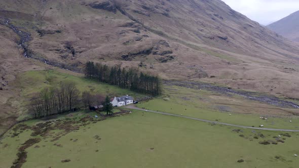 The Glencoe Valley and a Small House Surrounded by Mountains in the Highlands