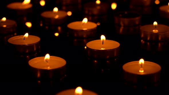 Candles are burning on a black background