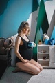 Pregnant woman with big belly in black bodysuit. Girl photoshoot in children's room playing with  - PhotoDune Item for Sale