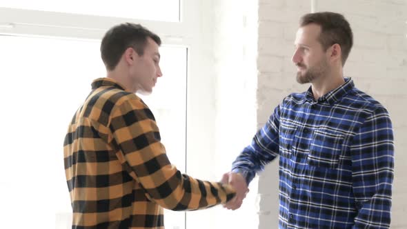 Casual Young Man Shaking Hand with Friend