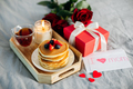Holiday breakfast or brunch set served on gray bed with flowers, gift box and candle. - PhotoDune Item for Sale