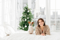 woman and pedigree dog wait together for New Year, pose at home in bedroom with white walls - PhotoDune Item for Sale