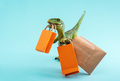Cute green dinosaur with shopping bags on a blue background. Cute humor shopping concept. - PhotoDune Item for Sale