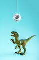 Happy cute green toy dinosaur dancing under disco ball on blue background.  - PhotoDune Item for Sale