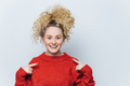 Adorable happy woman with cheerful expression, wears loose red sweater - PhotoDune Item for Sale