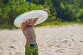 cute caucasian boy putting on rubber ring running going to swim. Vacation on sea side. - PhotoDune Item for Sale