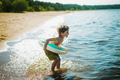 cute caucasian boy running into water with  laughter. Vacation on sea side. Happy childhood. - PhotoDune Item for Sale