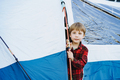 cute little caucasian boy looking out from touristic tent. Family camping concept - PhotoDune Item for Sale
