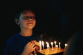 little cute caucasian boy making a wish before puffing out a candle on cake on his 9 birthday - PhotoDune Item for Sale