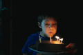 little cute caucasian boy making a wish puffing out candles on cake on his 9 birthday.  - PhotoDune Item for Sale