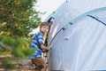 cute little caucasian boy helping to put up a tent. Family camping concept - PhotoDune Item for Sale