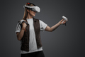 Shot of woman with innovative headset of virtual reality - PhotoDune Item for Sale
