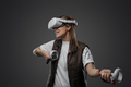Excited woman enjoying innovative headset of virtual reality - PhotoDune Item for Sale