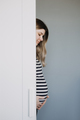 Candid creative portrait of the young pregnant woman in striped t-shirt. Pregnancy, expecting woman - PhotoDune Item for Sale