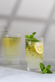 Lemonade with fresh lemon slices in a glass in the photo with a cinematic effect.  - PhotoDune Item for Sale