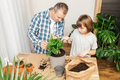 A teenage girl and dad are transplanting a monster houseplant into another pot. Home gardening  - PhotoDune Item for Sale