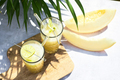 Refreshing melon smoothie with ice and lime in the sun. Summer cooling drinks. - PhotoDune Item for Sale