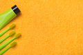 Green toothbrushes with paste tube on yellow bath towel. Importance of oral health care. - PhotoDune Item for Sale