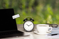 individual income tax return form for payment, alarm clock, coffee cup and laptop on working desk - PhotoDune Item for Sale