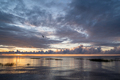 Calm lakeside at sunset in summer evening. Grassy seashore in evening against a cloudy sunset sky. - PhotoDune Item for Sale