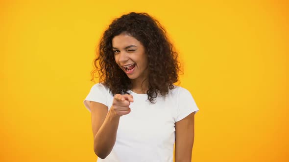 Joyful African American Millennial Pointing at Camera, Hey You Gesture, Flirt