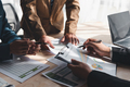 Team Business people planning at a meeting business consultant pointing to graph and analyzing chart - PhotoDune Item for Sale