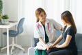 Asian female doctor asks about the patient's condition and makes recommendations about medications - PhotoDune Item for Sale