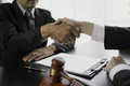 Lawyer shaking hands with a client making about documents, contracts, agreements - PhotoDune Item for Sale