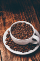 White cup full of roasted coffee beans - PhotoDune Item for Sale