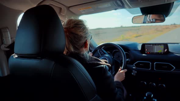 Woman Driver Car Travelling Steering Wheel. Tourism Driving On Country Road SUV. Car Travel.