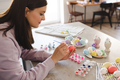Woman making Easter decorations at home - PhotoDune Item for Sale