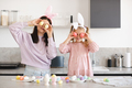 Woman having fun with kid girl with Easter eggs together - PhotoDune Item for Sale