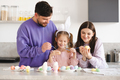 Happy family making Easter decorations together at home - PhotoDune Item for Sale