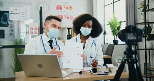 Male and Female Doctors Recording Video for Internet Audience and Explaining Chemical formula