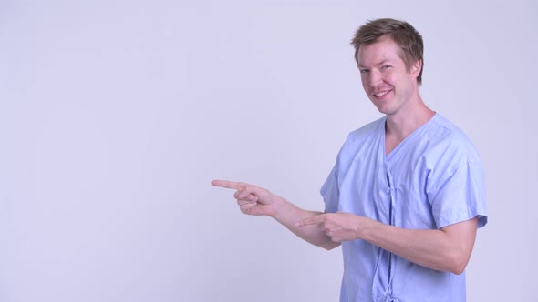 Happy Young Man Patient Pointing Fingers and Showing Something