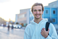 Student smiling while standing on campus at his university. A cheerful young man with a backpack - PhotoDune Item for Sale